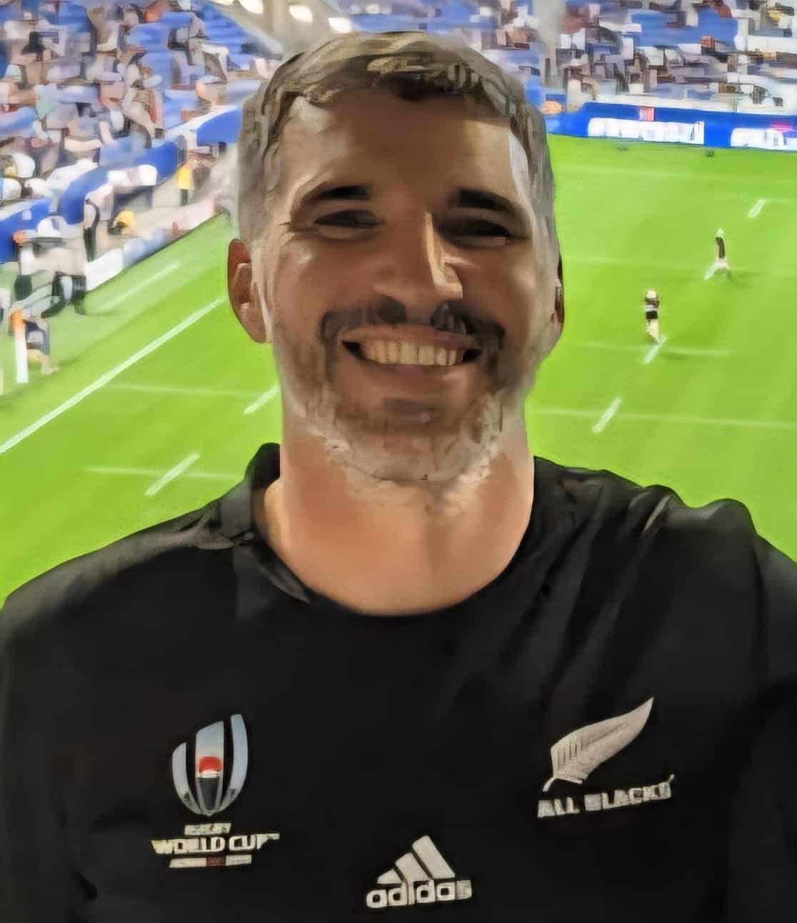 Man in All Blacks jersey at rugby match