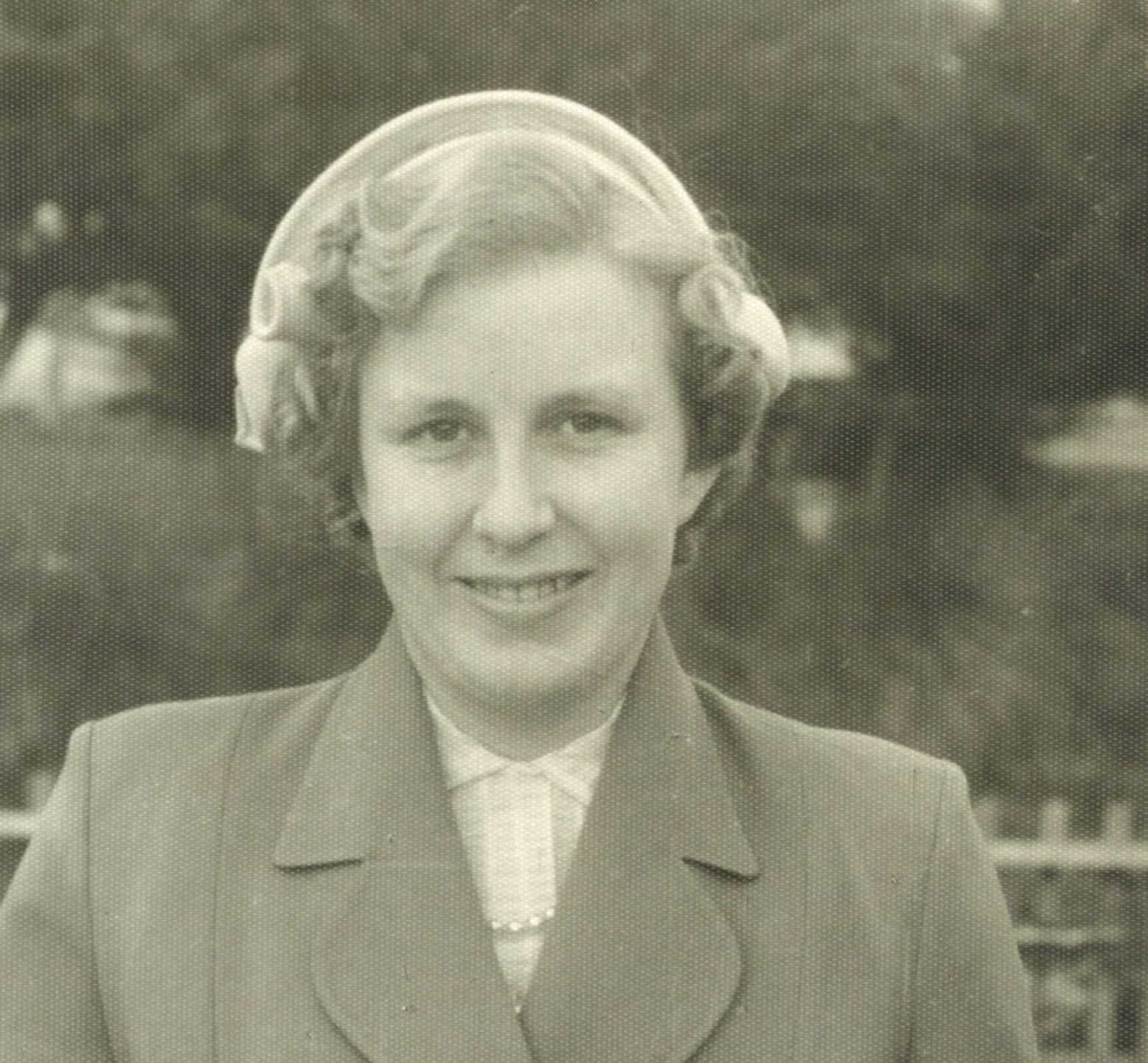 Vintage photo of smiling woman with a bouquet