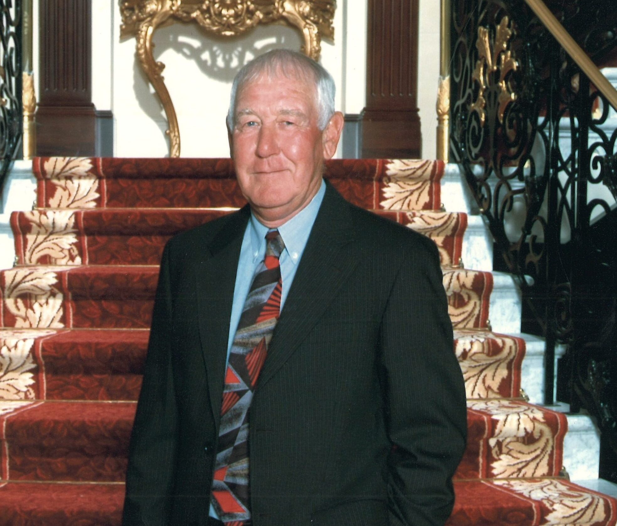 Man in suit on grand staircase