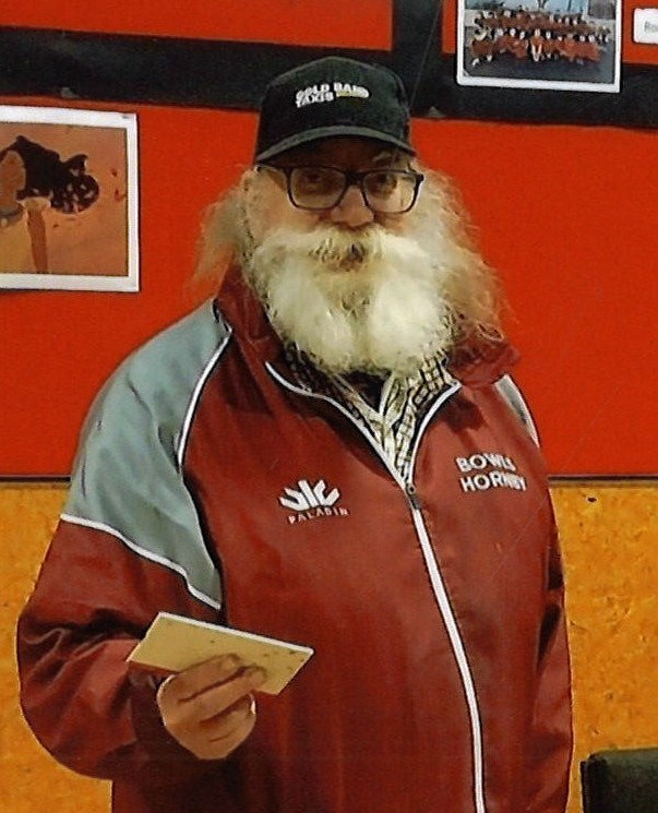 Man in sports jacket holding a card