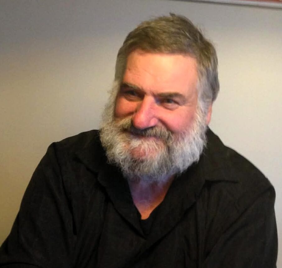 Smiling man with beard at a table