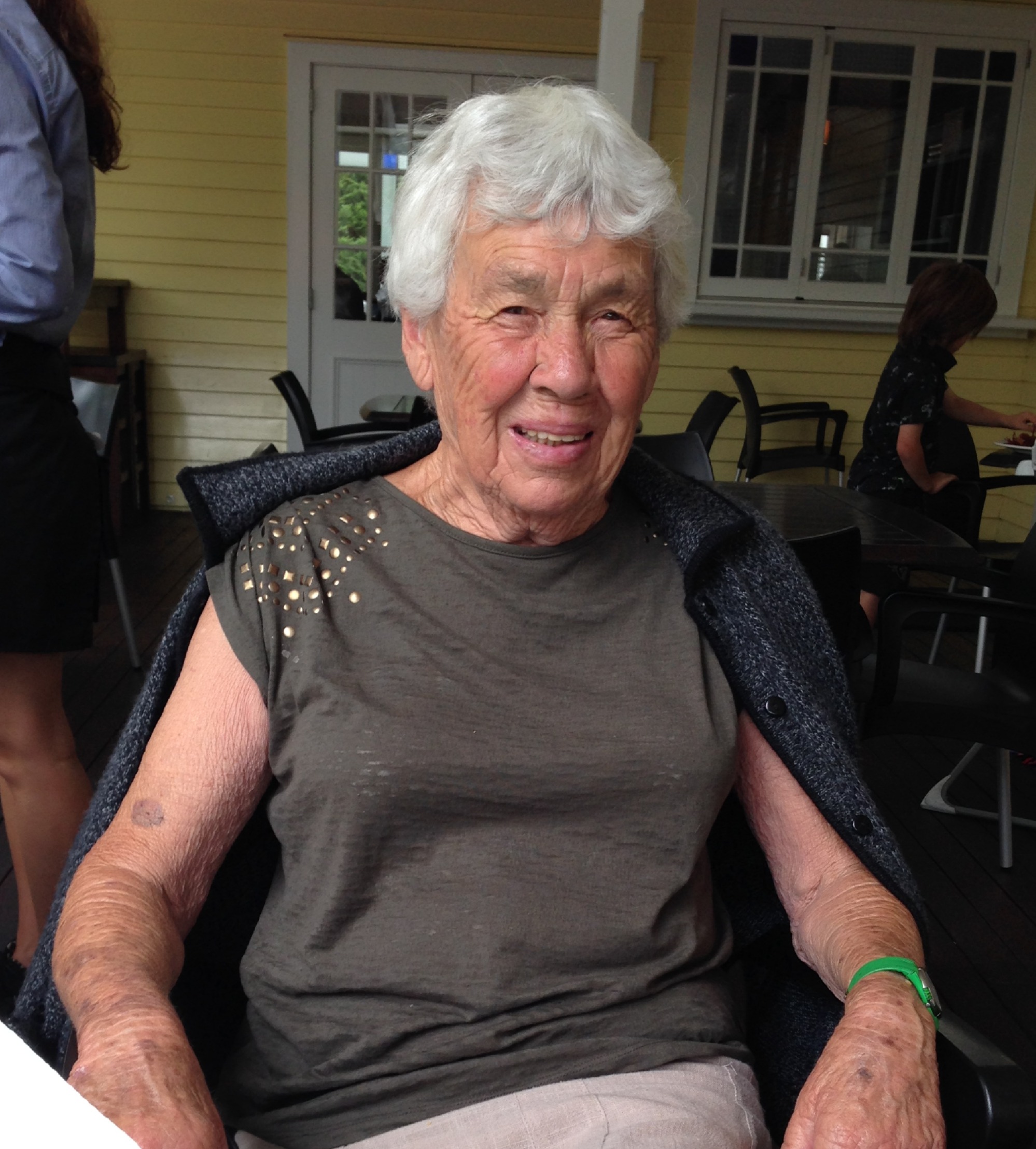 Elderly woman smiling at restaurant table